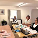 Three attendees discussing at empowering women workshop